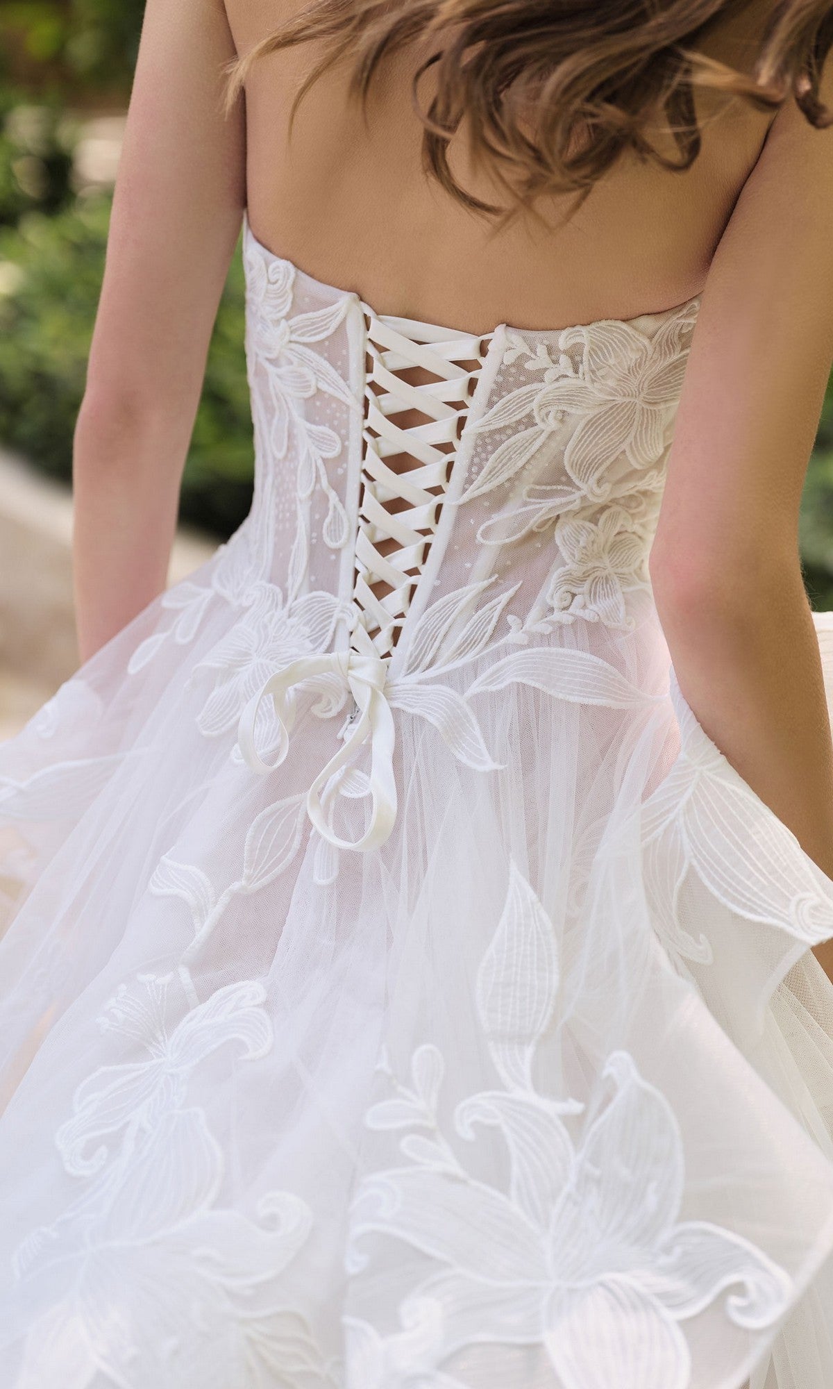 A close-up of the back of the Long White Wedding Dress: Andrea and Leo WL059, featuring strapless design, lace-up detailing, and delicate floral lace embroideryโideal for a romantic bridal look.